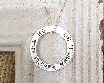 May include: Silver necklace with a round pendant that reads "The places you'll go".