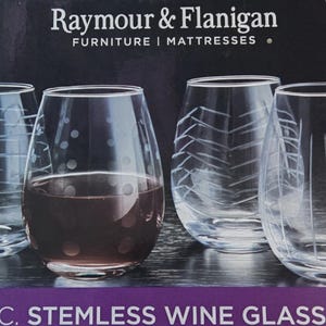 May include: A 4-piece stemless wine glass set from Raymour & Flanigan. The clear glass set features four distinct etched patterns: horizontal lines, polka dots, chevron zigzags, and vertical lines. One glass contains a dark liquid.