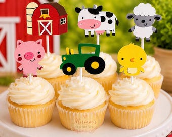 May include: A set of six cupcakes topped with paper farm-themed decorations including a red barn, a black and white cow, a grey sheep, a pink pig, a green tractor, and a yellow chick, all arranged on a white plate with a watermark logo.