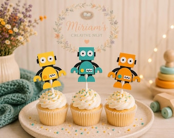 May include: Three cupcakes topped with yellow, teal, and orange robot-shaped paper toppers on white sticks. Each cupcake has white frosting with colorful sprinkles, arranged on a round plate. The robots feature circular eyes and rectangular bodies.