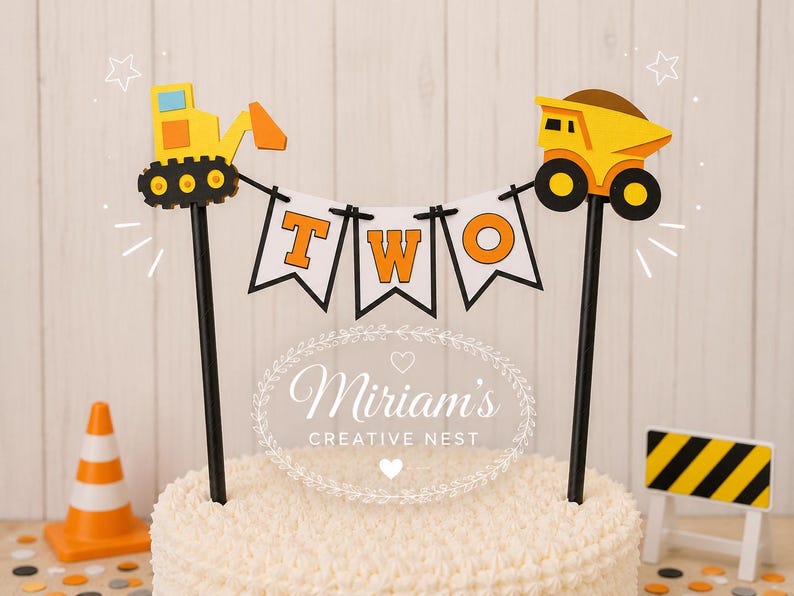 May include: A cake topper featuring a yellow excavator and a yellow dump truck connected by a white banner with the orange letters T, W, and O. The construction-themed decoration is mounted on two black sticks and includes a small orange traffic cone.