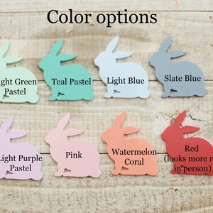 May include: A collection of bunny-shaped cutouts in various pastel colors, including light green, teal, light blue, slate blue, light purple, pink, watermelon coral, and red. The text "Color options" is at the top.