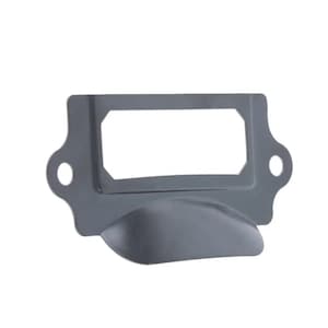 May include: Black metal drawer pull with a rectangular label holder. The pull has a curved bottom and a rounded edge.