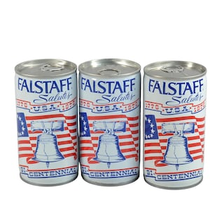 May include: Three vintage Falstaff beer cans. Each can features a patriotic design with the text "Falstaff Salutes U.S.A. 1976" and a depiction of the Liberty Bell against a backdrop of the American flag. The cans are silver with a white, red, and blue design.