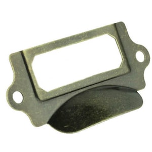 May include: Antique brass drawer pull with a rectangular label holder. The pull has a curved, indented handle and a beveled edge.