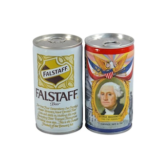 May include: Two vintage Falstaff beer cans. One can features the Falstaff logo in gold and brown on a white background, with text. The other can displays George Washington with patriotic imagery and the quote "I cannot tell a lie."