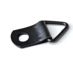 May include: Black metal picture hanging hook with a triangular ring and a round hole.