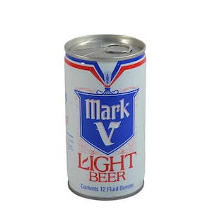 May include: A vintage Mark V Light Beer can. The can is white with a blue and red design. The text "Mark V" is in a blue shield, and "LIGHT BEER" is in red. The can contains 12 fluid ounces.