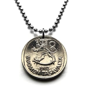 May include: A silver necklace with a 1982 Finnish coin pendant featuring the Finnish lion and the text "SUOMEN TASAVALTA".