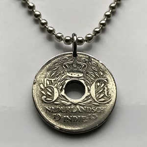May include: Silver necklace with a 50 cent coin pendant from the Netherlands Indies. The coin has a hole in the center and features a crown and the text "50 ct NEDERLANDSCH-INDIE".