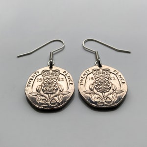 May include: A pair of silver earrings featuring 1982 twenty pence coins with the British royal coat of arms and a rose design.