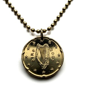 May include: A gold necklace with a 2003 Irish Euro coin pendant featuring a harp and the word "EIRE".