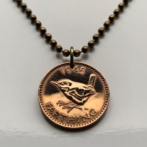May include: A 1945 British Farthing coin necklace featuring a wren design. The coin is on a brass chain.