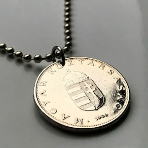 May include: Silver necklace with a Hungarian 10 Forint coin pendant featuring the coat of arms of Hungary and the year 1994.