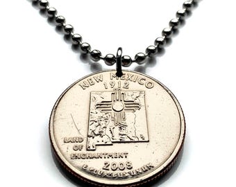 May include: A silver chain necklace with a silver quarter coin pendant. The coin features the state of New Mexico with the words "New Mexico 1912" and "Land of Enchantment 2008".