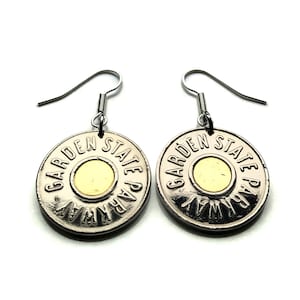 May include: Silver-toned earrings featuring a circular design with the words "GARDEN STATE PARKWAY" around the edge. Each earring has a gold-colored center and a silver hook for pierced ears. The earrings are displayed against a white background.