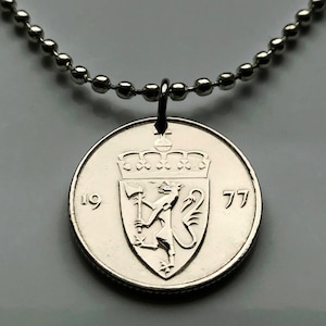 Puede incluir: Collar de plata con un colgante de moneda de plata que presenta el escudo de armas noruego y el año 1977.