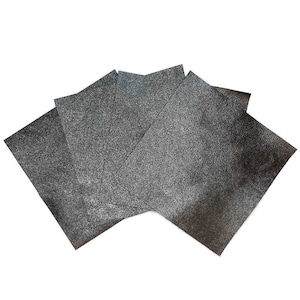 May include: A collection of five dark gray sheets of textured material, fanned out against a white background. The sheets have a slightly rough, speckled appearance, suggesting a metallic or glittery finish. The edges are clean and defined.