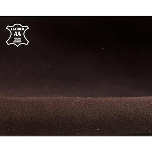 May include: Close-up of a dark brown leather material with a textured surface. The image features a white logo in the upper left corner that reads "LEATHER AA ITALIAN LEATHER COMPANY". The leather appears to be soft and pliable.