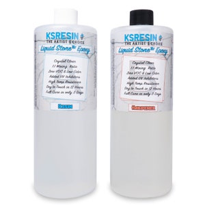May include: Two clear plastic bottles labelled "KSRESIN" with the text "The Artist's Choice Liquid Stone Epoxy". The bottle on the left is labelled "Resin" and the bottle on the right is labelled "Hardener". Both bottles have a white background with black text and a blue and white marble pattern.