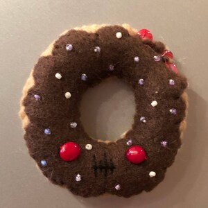 Chocolate Frosted Yellow Cake Zombie Donut Magnet with Purple Sprinkles and Red Eyes