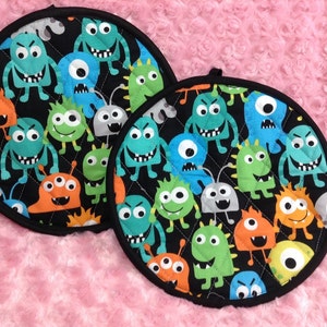 Cute Colorful Monster With Black Background Pot Holders