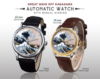 May include: Two automatic watches with manual winding, featuring the "Great Wave off Kanagawa" design. One has a 42 mm silver-tone case with a black leather strap. The other has a 38 mm two-tone case with a brown leather strap.