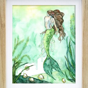 May include: Watercolor painting of a mermaid with long brown hair and a green tail, swimming in a green and blue ocean with yellow fish. The mermaid is wearing a pearl necklace and a gold bracelet.