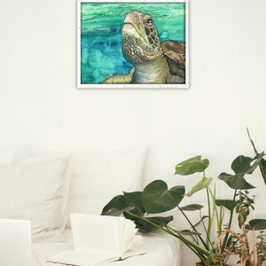 May include: A watercolor painting of a sea turtle swimming in the ocean. The turtle is looking up at the surface of the water. The painting is framed in a white frame.