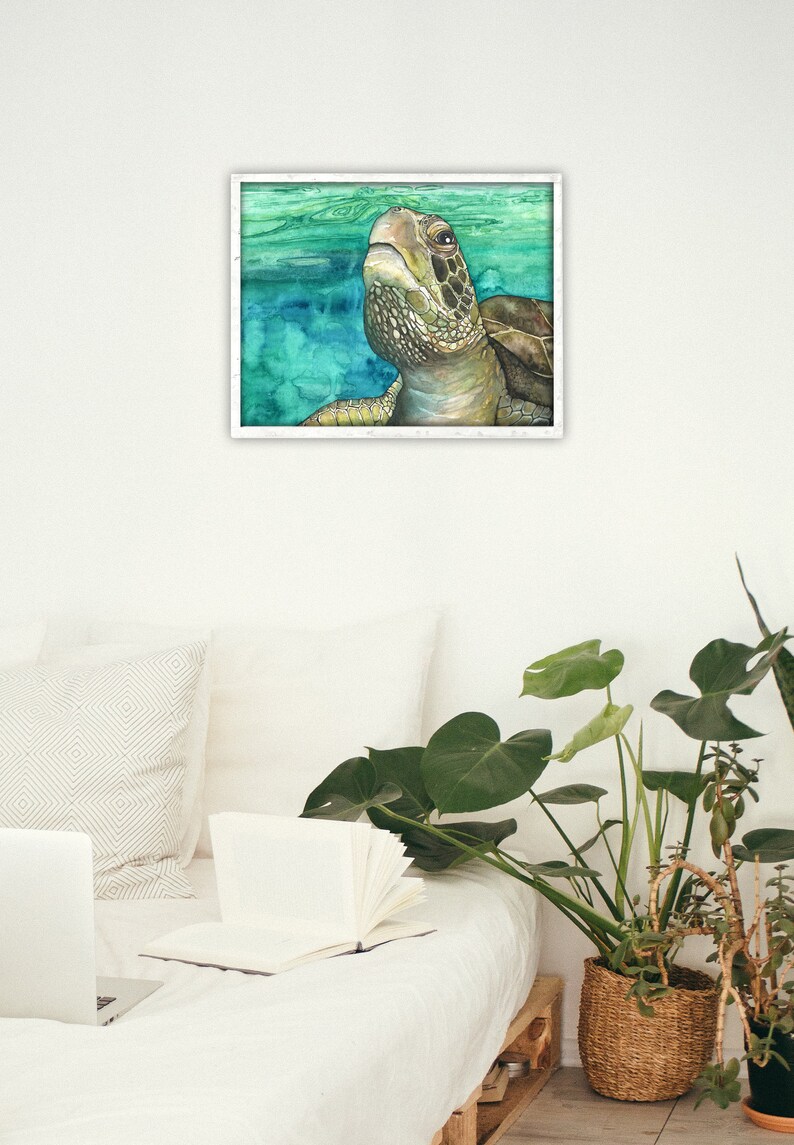 May include: A watercolor painting of a sea turtle swimming in the ocean. The turtle is looking up at the surface of the water. The painting is framed in a white frame.