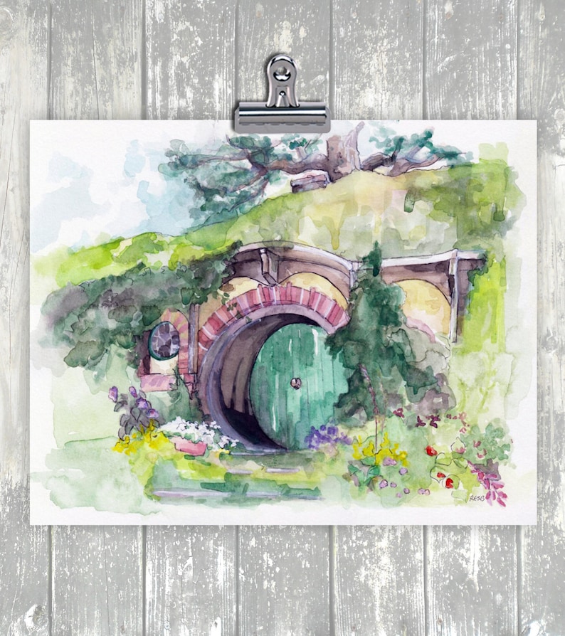 May include: A watercolor painting of a hobbit hole with a green door. The door is surrounded by lush greenery and flowers. The hobbit hole is built into a hillside and has a brick archway.