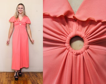 May include: A coral pink maxi dress with a keyhole cutout at the bust and ruffled sleeves.