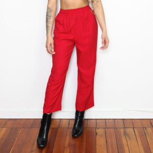 May include: Red wide-leg pants with a high waist and a relaxed fit.