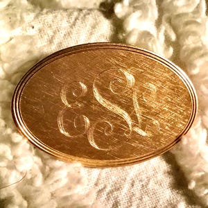 May include: A white ceramic mug with a black handle and the text "But First, Coffee" in a black, handwritten-style font. The mug is on a white surface.