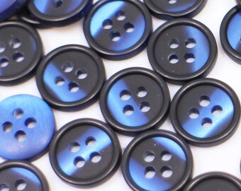 May include: A collection of blue and black plastic buttons with four holes each. The buttons have a marbled effect with a blue swirl on a black background.