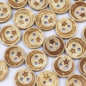 May include: A collection of wooden buttons featuring a crescent moon and two stars design. The buttons are light brown with a natural wood grain.