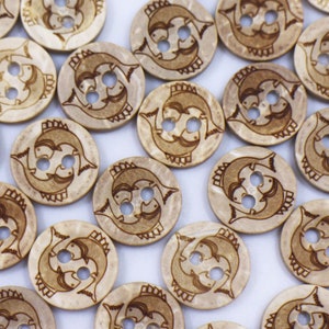 May include: A collection of wooden buttons featuring a fish design. The buttons are light brown with a darker brown fish design. The buttons are all different sizes and shapes.