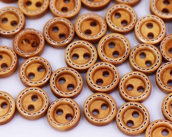 May include: A collection of brown wooden buttons with a decorative stitched border. The buttons have two holes each.