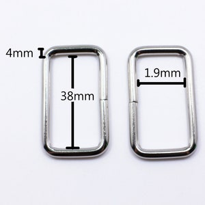 May include: Two silver metal rectangular rings. The larger ring measures 4.8 cm by 9.7 cm. The smaller ring measures 1.9 cm by 3.8 cm.