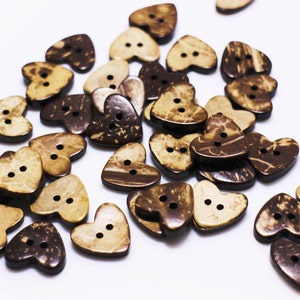 May include: A collection of brown and beige heart-shaped coconut shell buttons.