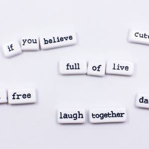 May include: White tiles with black lettering spelling out the phrase "if you believe feel free laugh together full of live cute dad mom".