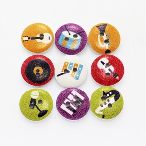 May include: Nine colourful wooden buttons with different musical instrument designs. The buttons are round and have a textured surface. The designs include a guitar, a drum, a trumpet, a record player, a xylophone, a violin, a microphone, a piano, and a saxophone.
