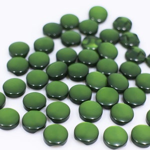 May include: A pile of round, green buttons. The buttons are smooth and glossy.