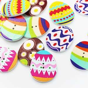 May include: Assortment of colorful wooden Easter egg buttons with various patterns, including stripes, polka dots, and zigzags.