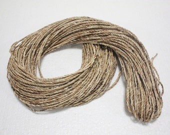 May include: A long strand of natural fiber rope, twisted and coiled, in a light brown color.