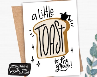 May include: A white greeting card with the words "a little TOAST to the grad!" in black script, featuring a cartoon toast illustration. The card is on a brown envelope, with a small print-at-home icon.