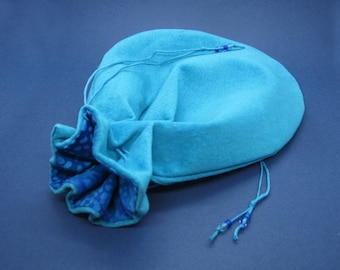 Bright blue suede drawstring pouch with blue fabric lining