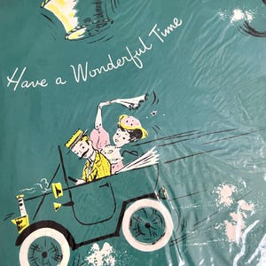 May include: Teal-colored wrapping paper with a vintage illustration of a couple in a car, and other figures in the sky. The text "Have a Wonderful Time" is written in cursive.