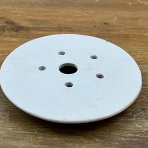 May include: A set of three ceramic nesting bowls in shades of blue, green, and white. The bowls feature a speckled design and varying sizes, perfect for food preparation or serving.