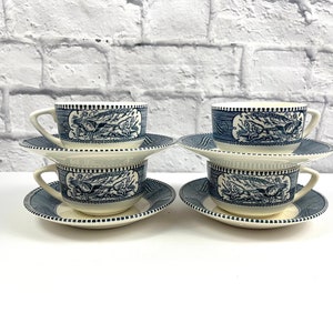 May include: Set of four blue and white teacups and saucers with a vintage floral design.